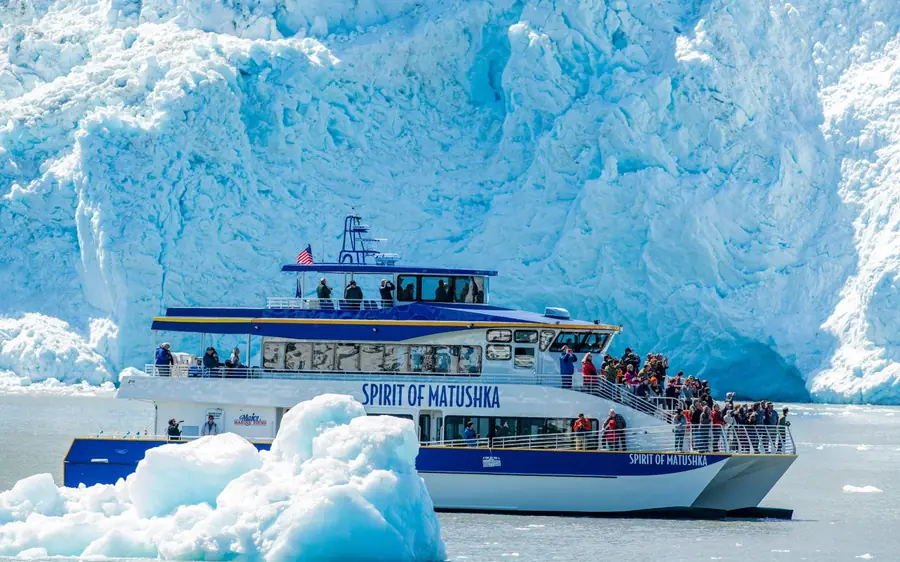 A cruise boat among floating ice in Kenai Fjords National Park, Alaska
